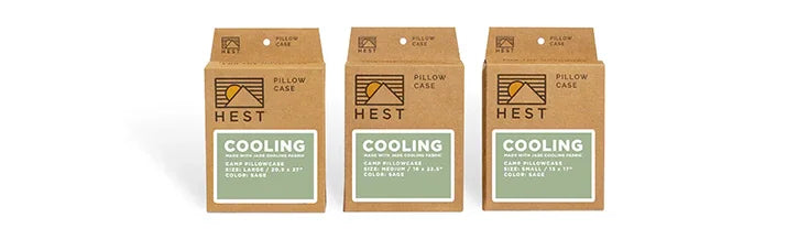 Three Hest cooling pillowcase packages in brown boxes, labeled for camp or travel use