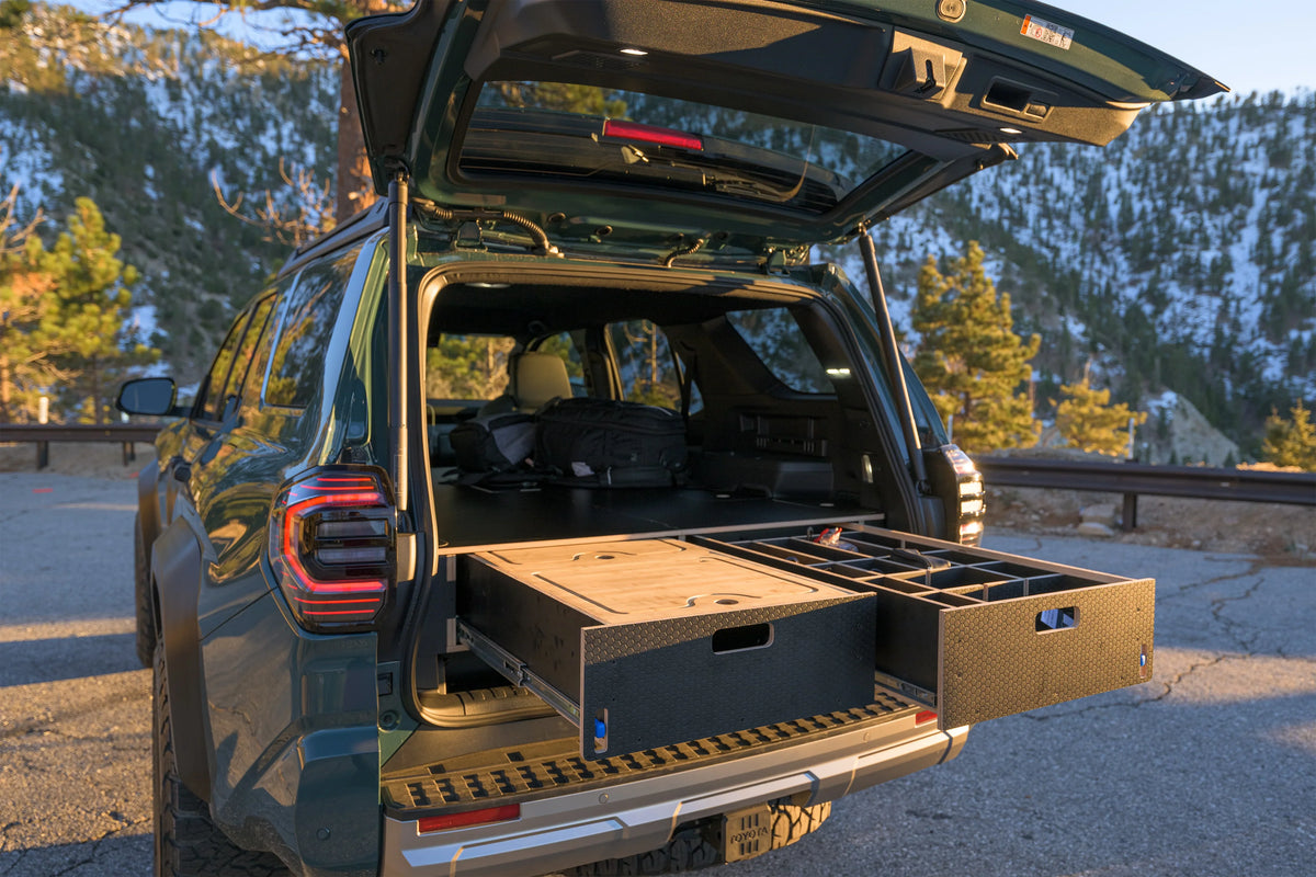 SUV with open trunk showing custom drawer storage system for vehicle organization outdoors