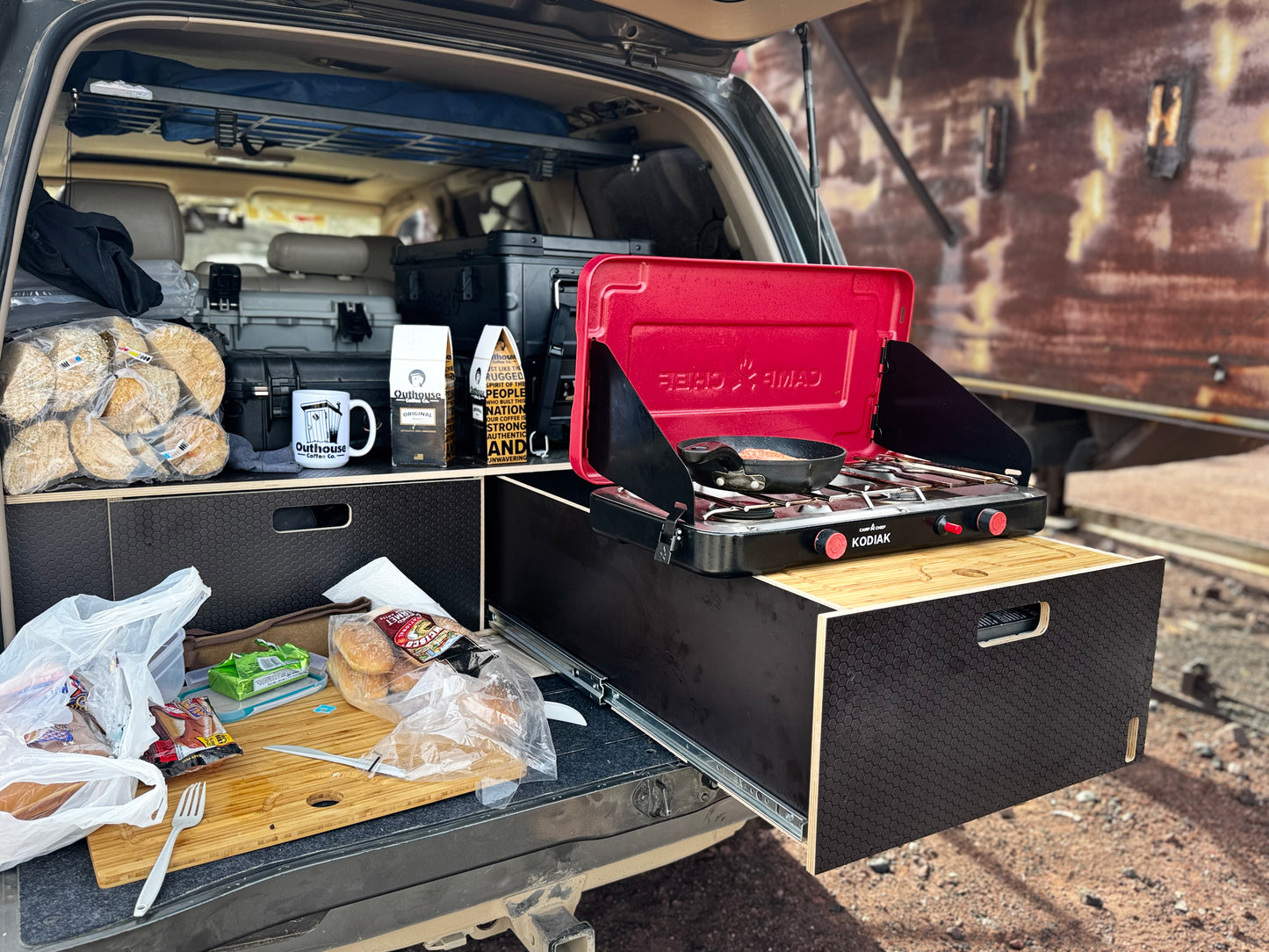 Vehicle storage drawer system with pull-out kitchen setup and portable camp stove