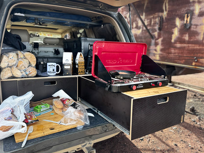 Vehicle storage drawer system with pull-out kitchen setup and portable camp stove