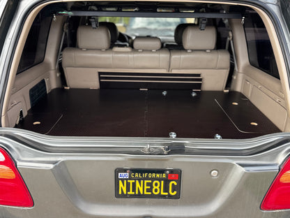 Vehicle rear cargo area with custom fitted solid wood storage drawer system installed