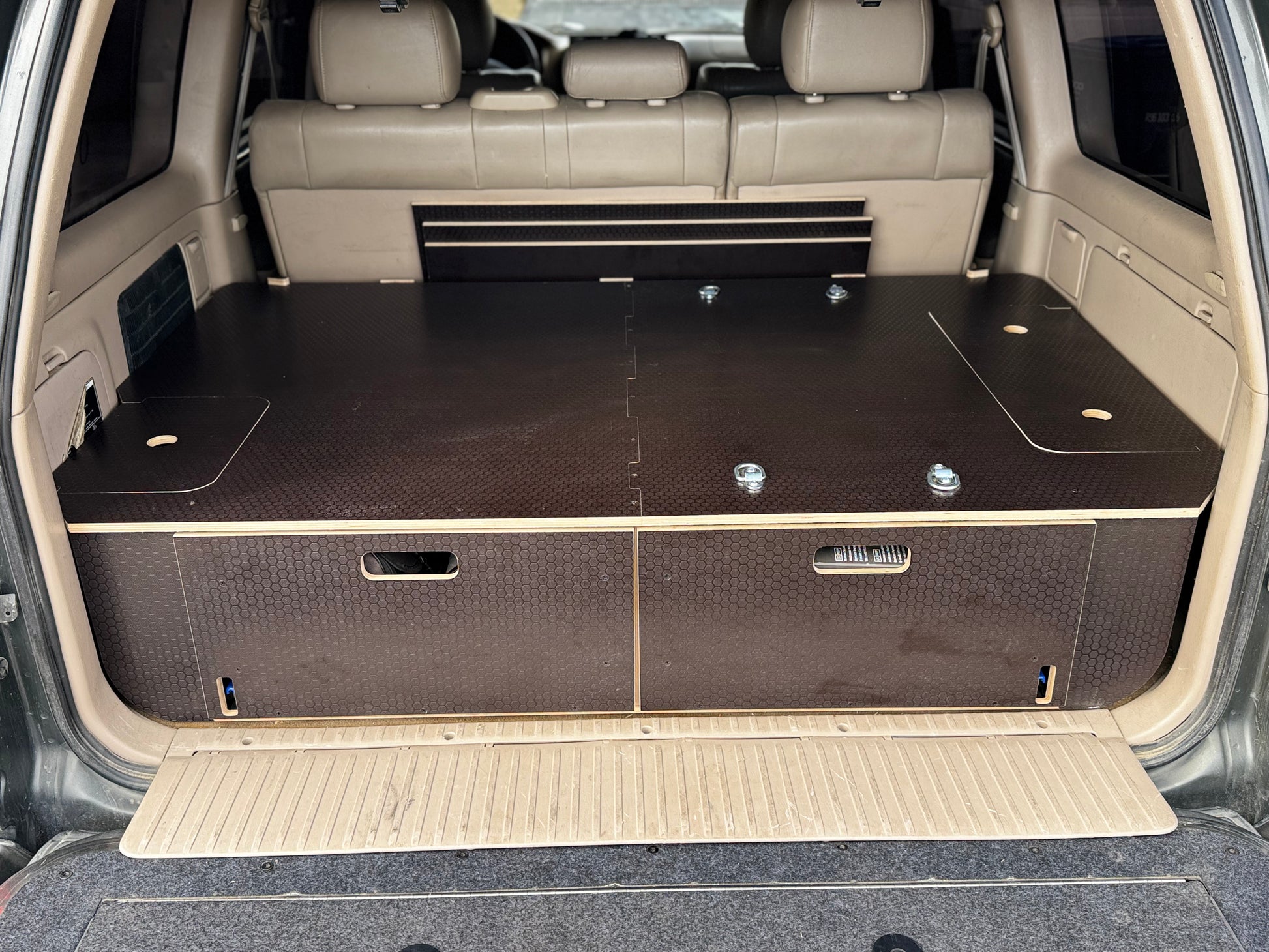Custom wood vehicle drawer system for SUV cargo storage, two drawers, black textured finish