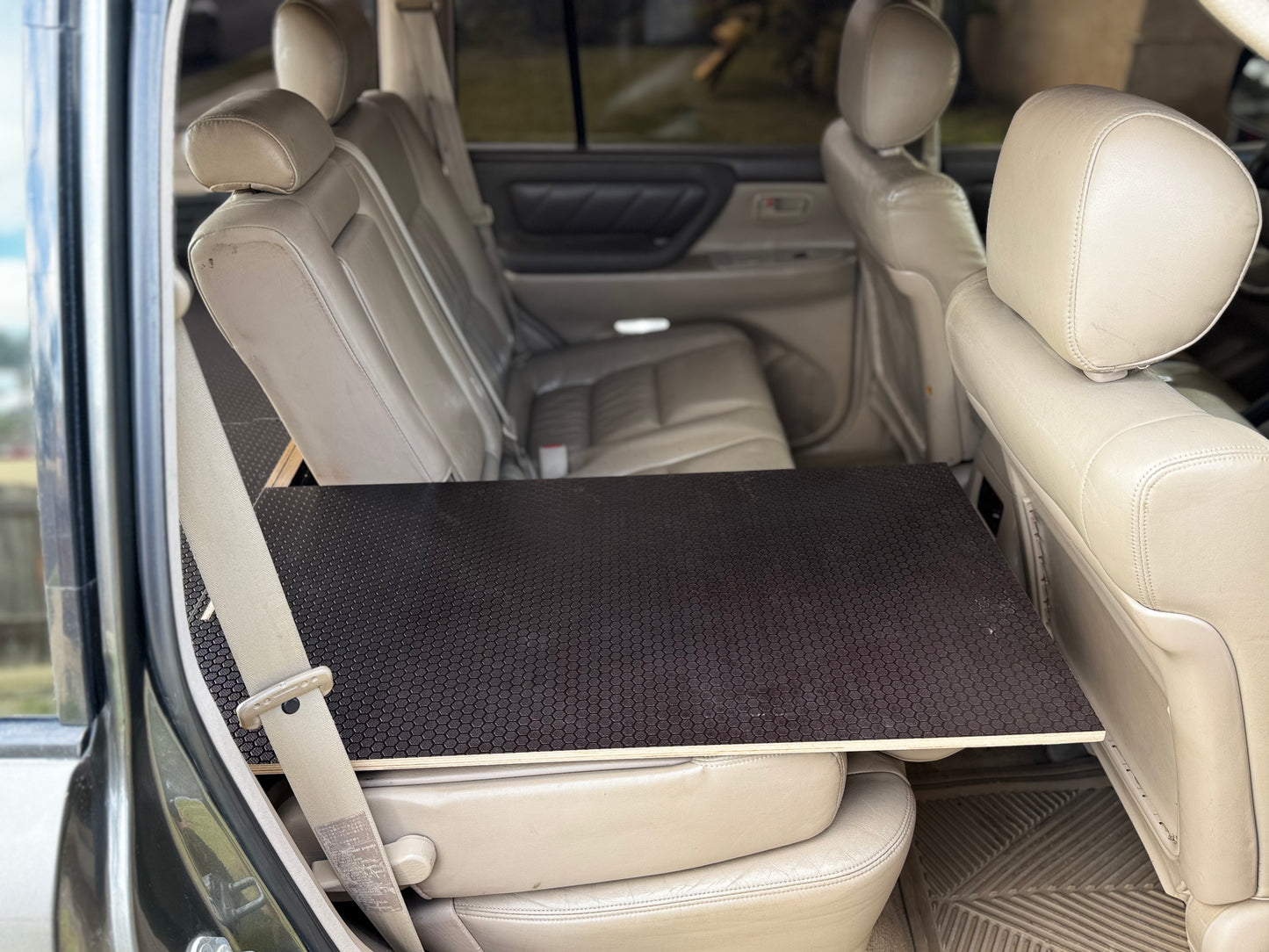 Vehicle back seat with custom black storage platform installed for car organization