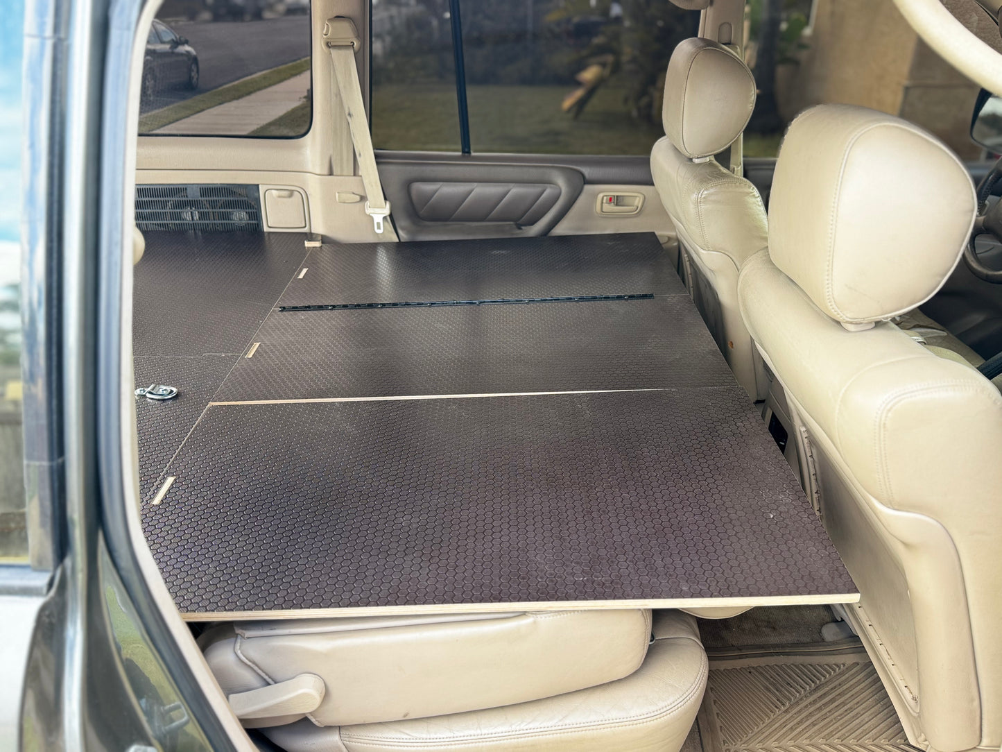 Custom vehicle drawer system installed in SUV with folded seats and black platform