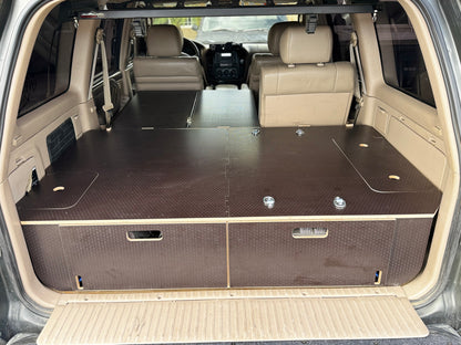 Custom wood drawer system installed in SUV cargo area for organized vehicle storage.