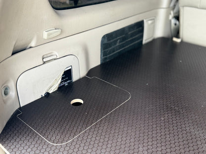 Vehicle cargo area with custom hex-pattern storage platform and built-in access hatch