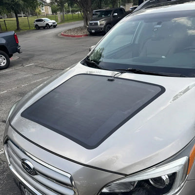 Subaru Outback with 90W hood solar panel installed in parking lot