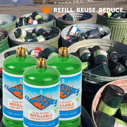 Three green Flame King refillable propane cylinders in front of bins of used fuel canisters.