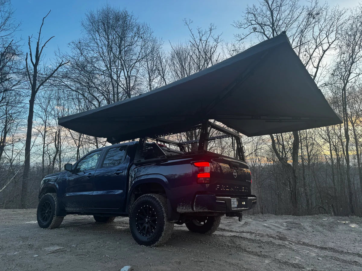 Pickup truck with a large roof awning for outdoor camping and vehicle storage solutions
