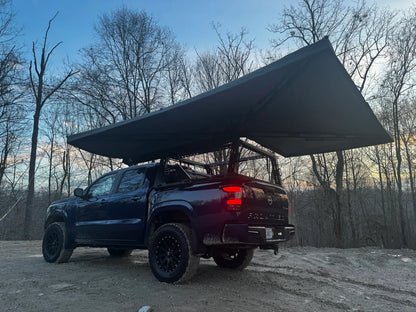 Pickup truck with a large roof awning for outdoor camping and vehicle storage solutions