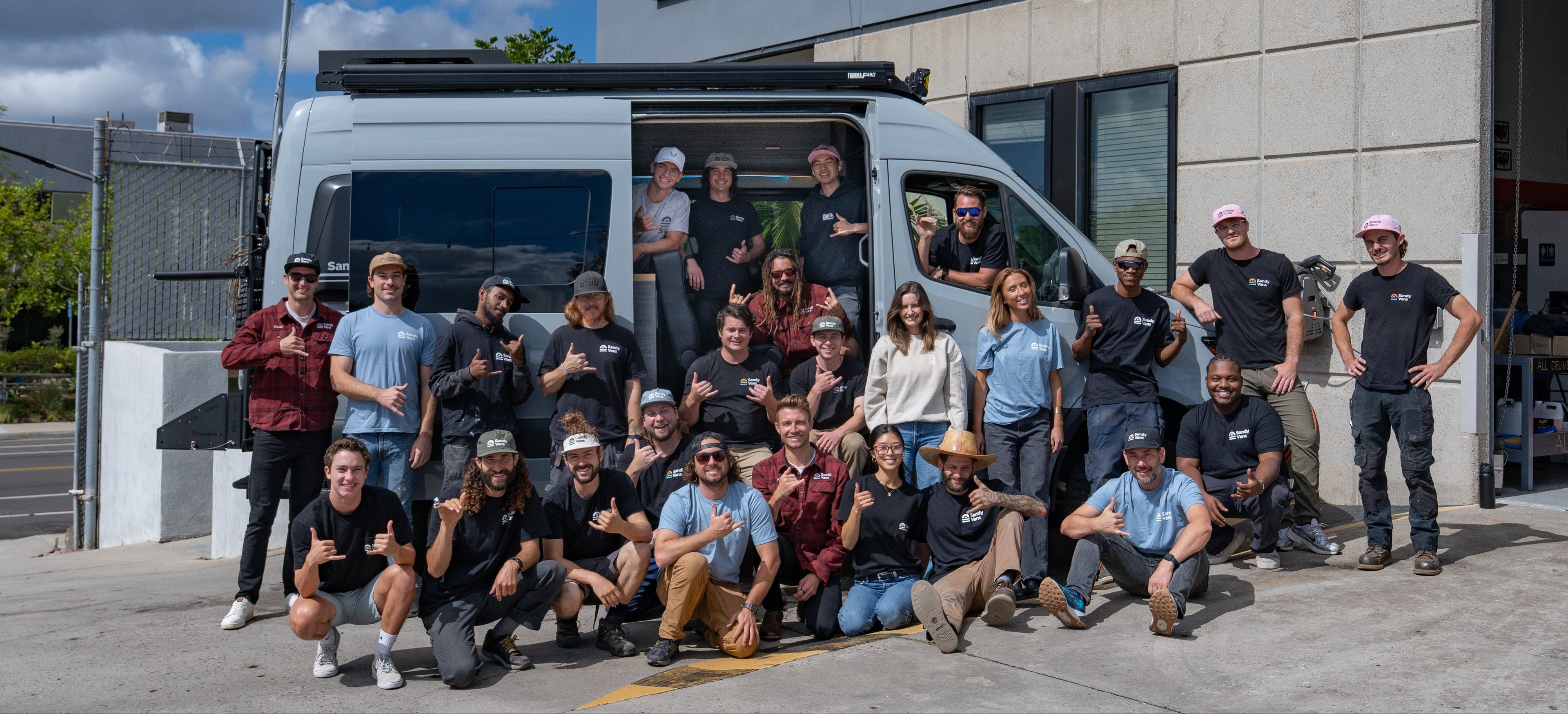 Group of people posing in front of Solid Wood Worx shop.