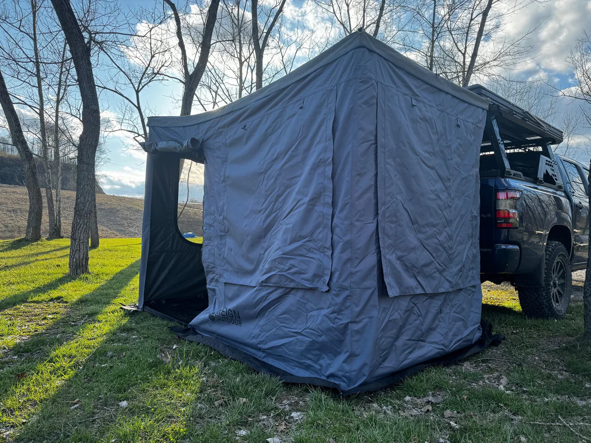 Pickup truck with attached outdoor awning tent for vehicle camping storage, set up in nature